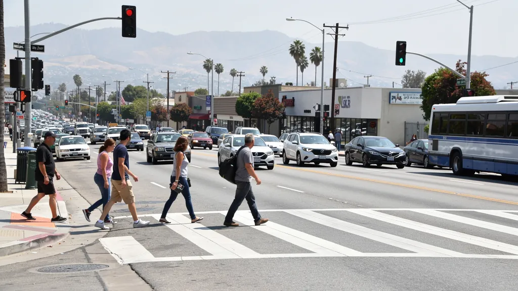 Busy crosswalk where pedestrians cross traffic in Van Nuys
